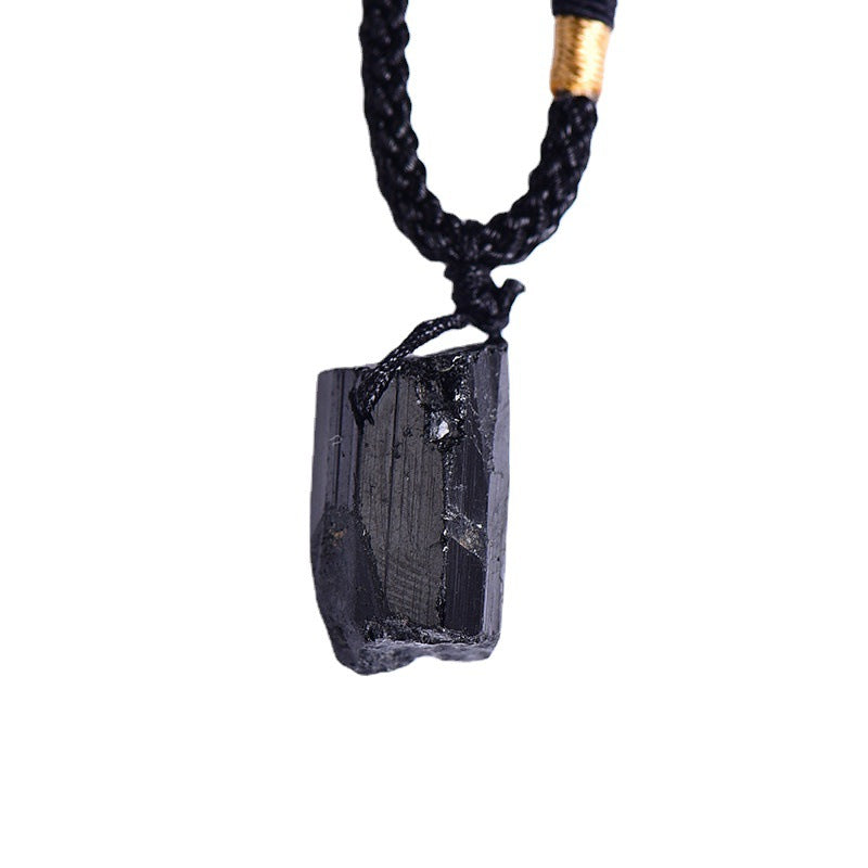 Closeup of natural raw black tourmaline pendant, rough crystal point on adjustable braided necklace cord, wholesale crystal jewelry