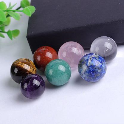 Flat lay of 7 natural chakra gemstone spheres, mixed crystal balls set, wholesale healing crystals