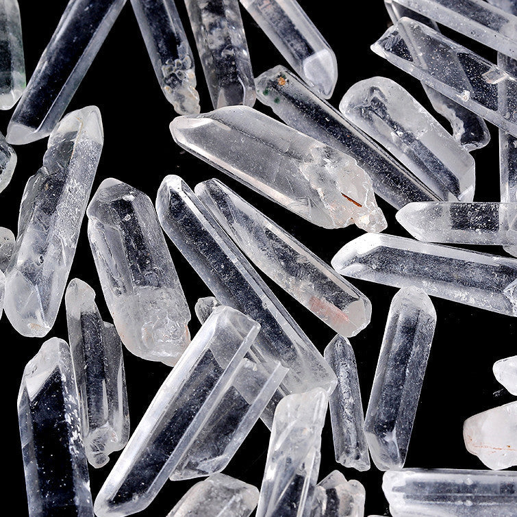 Bulk raw clear quartz single crystal points isolated on white background for wholesale