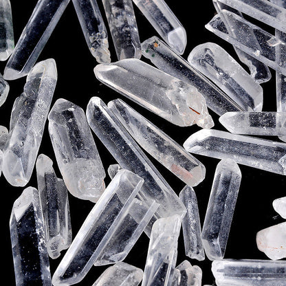 Bulk raw clear quartz single crystal points isolated on white background for wholesale