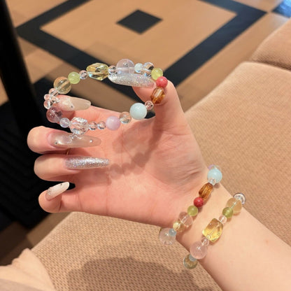 Handmade multicolor crystal bracelet featuring citrine and clear quartz beads, held in hand