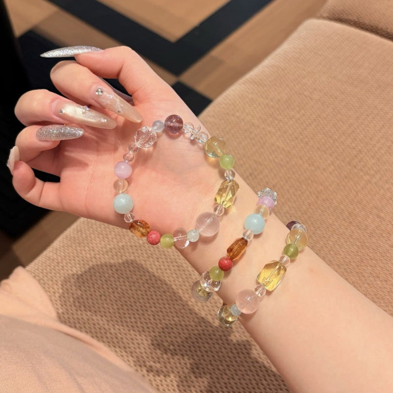 Handmade multicolor crystal bracelet featuring citrine and clear quartz beads, held in hand