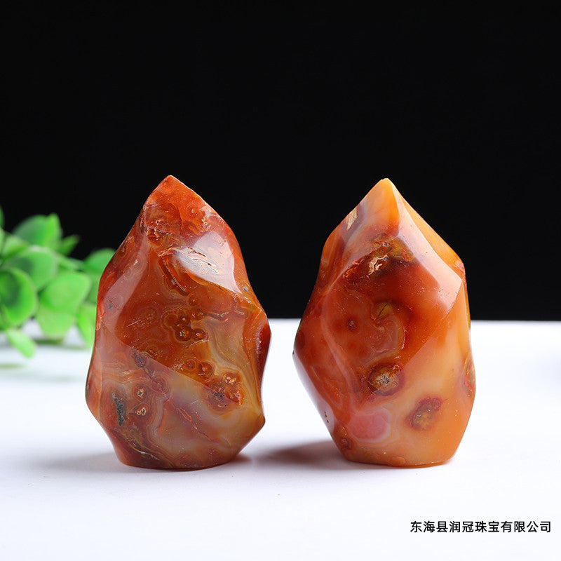 Two Polished Red Carnelian Flame Crystal Towers on White Background