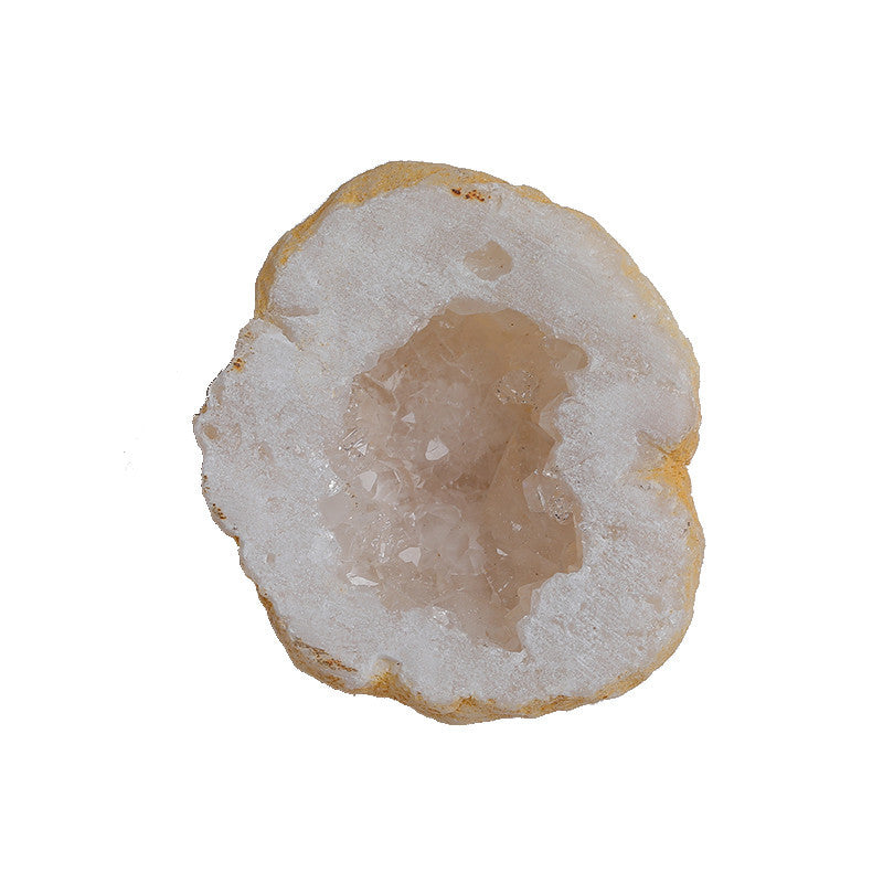 Close-up of natural agate geode half, sparkling clear quartz crystals inside rough agate shell