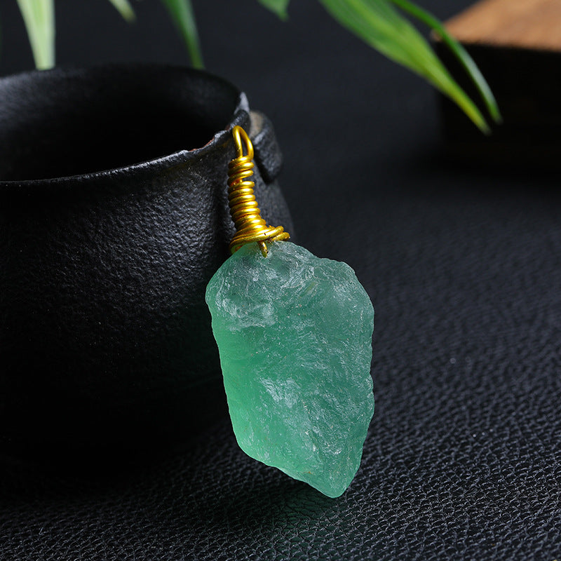 Single Raw Green Fluorite Wire Wrapped Pendant on Dark Background