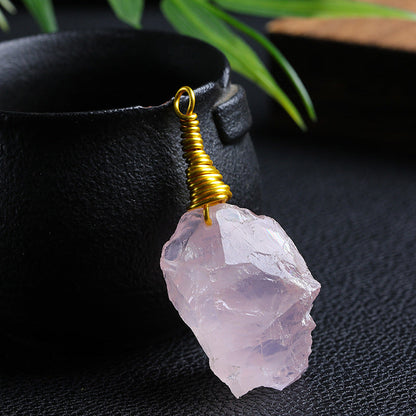 Single Raw Rose Quartz Wire Wrapped Pendant on Dark Background